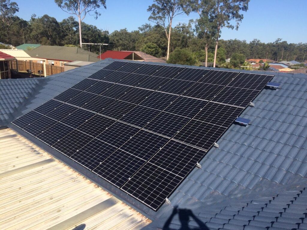 Installing solar panels on a residential rooftop, securely mounting the panels to maximise sun exposure and optimise energy efficiency for sustainable power generation.